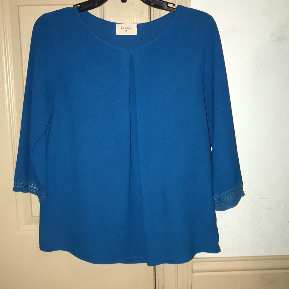 Royal blue blouse with detailing on sleeves.